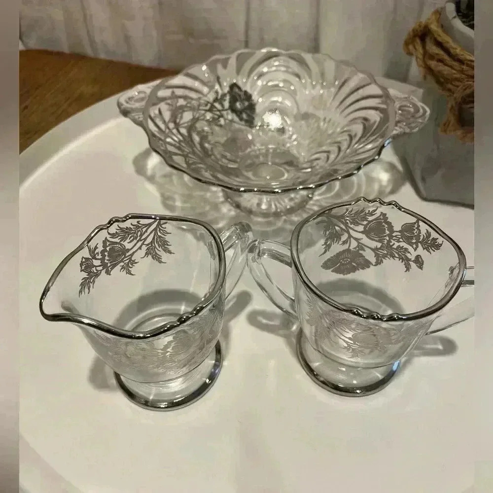 Glass candy dish, creamer and sugar bowl, flowers and silver rims.